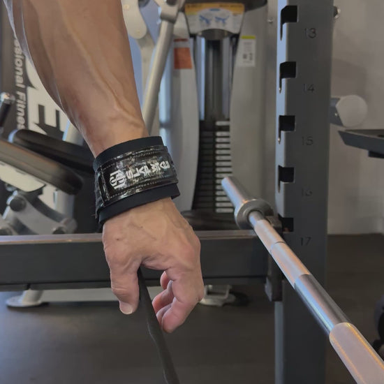 Slap Wraps V2 auto-wrapping onto a barbell in one motion